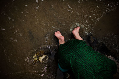 Low section of person on wet rock