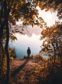 Man standing in front of lake