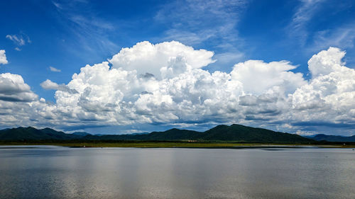 Scenic view of lake and mountains against sky