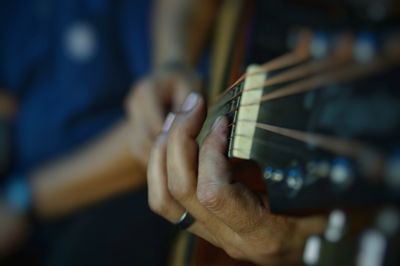 Close-up of hands playing guitar