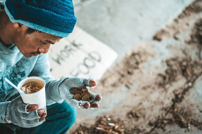 High angle view of man holding coffee cup