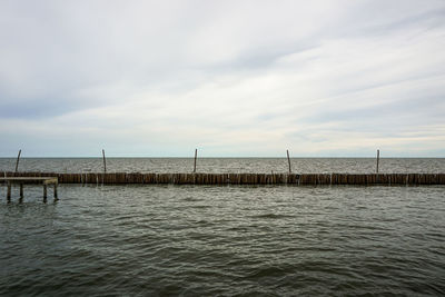 Pier over sea against sky