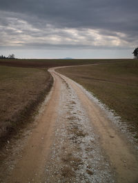 Dirt road along countryside landscape