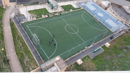 High angle view of soccer field against buildings