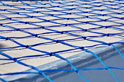 Close up on blue net on pool floor