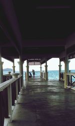 View of built structure by sea