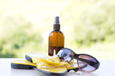 Close-up of slippers and sunglasses on table