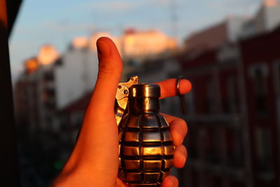 Cropped hand of woman holding light bulb