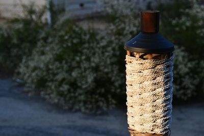 Close-up of tiki torch against plants