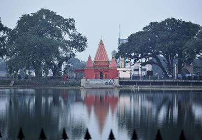 Panoramic view of lake by building against sky