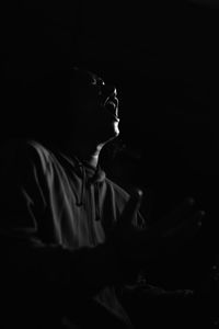 Side view of man looking at camera