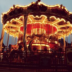 Low angle view of carousel at night