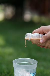 Close-up of hand holding glass of water