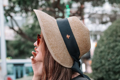 Portrait of woman with hat looking away