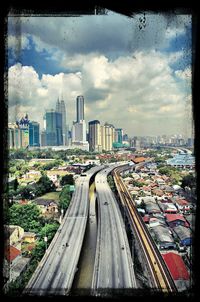 View of cityscape against cloudy sky