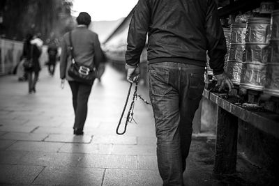 Rear view of people walking on street