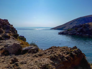 Scenic view from rocky coast and hills in oprna bay beach, stara baska on krk island , croatia.