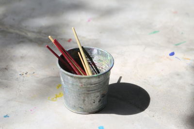 Close-up of paintbrushes in container on marble