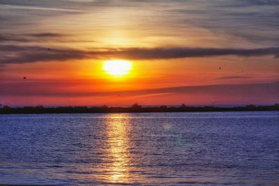 Scenic view of sea against orange sky