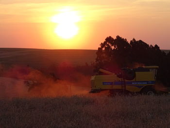 Scenic view of field against sky during sunset