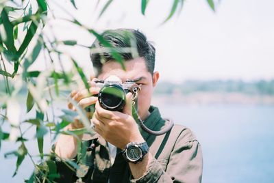 Portrait of young man photographing