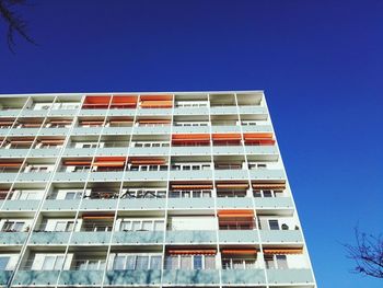Low angle view of buildings against clear blue sky