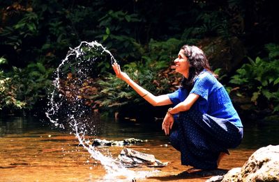 Side view of man playing in water