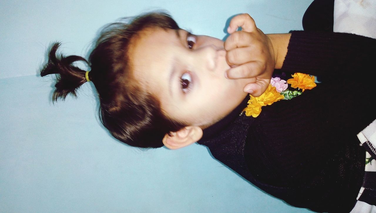 CLOSE-UP OF CUTE BABY GIRL WITH FLOWERS