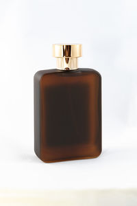 Close-up of tea light on table against white background