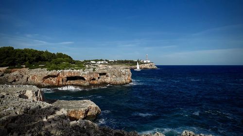 Scenic view of sea and buildings against sky