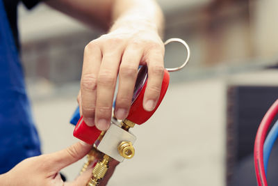 Cropped hand of person holding equipment