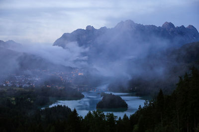 Fog rising above lake in the alps, italy