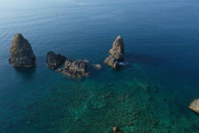 High angle view of rocks in sea