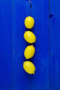 High angle view of lemons on blue wooden table