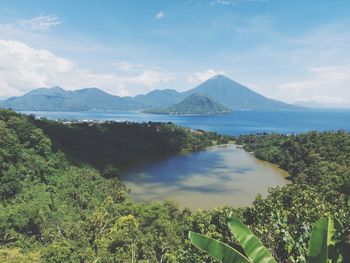 Scenic view of lake and mountains against sky