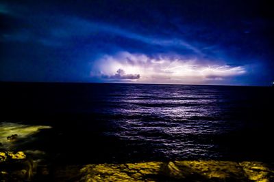 Scenic view of sea against sky at night