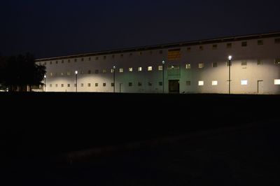 Illuminated building against sky at night