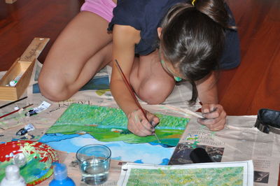 High angle view of siblings sitting on table