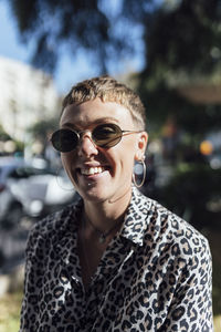 Smiling woman wearing sunglasses standing outdoors