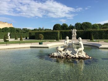 View of fountain in swimming pool against sky schonbrunn palace