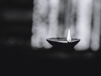 Close-up of illuminated lamp against black background