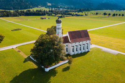 Aerial view of church near schwangau on summer day with alps in background