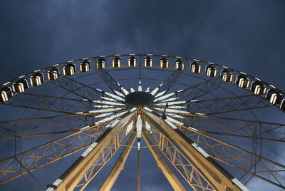 Low angle view of illuminated ferris wheel against sky