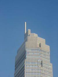 Low angle view of modern building against clear blue sky