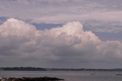 Scenic view of sea against cloudy sky