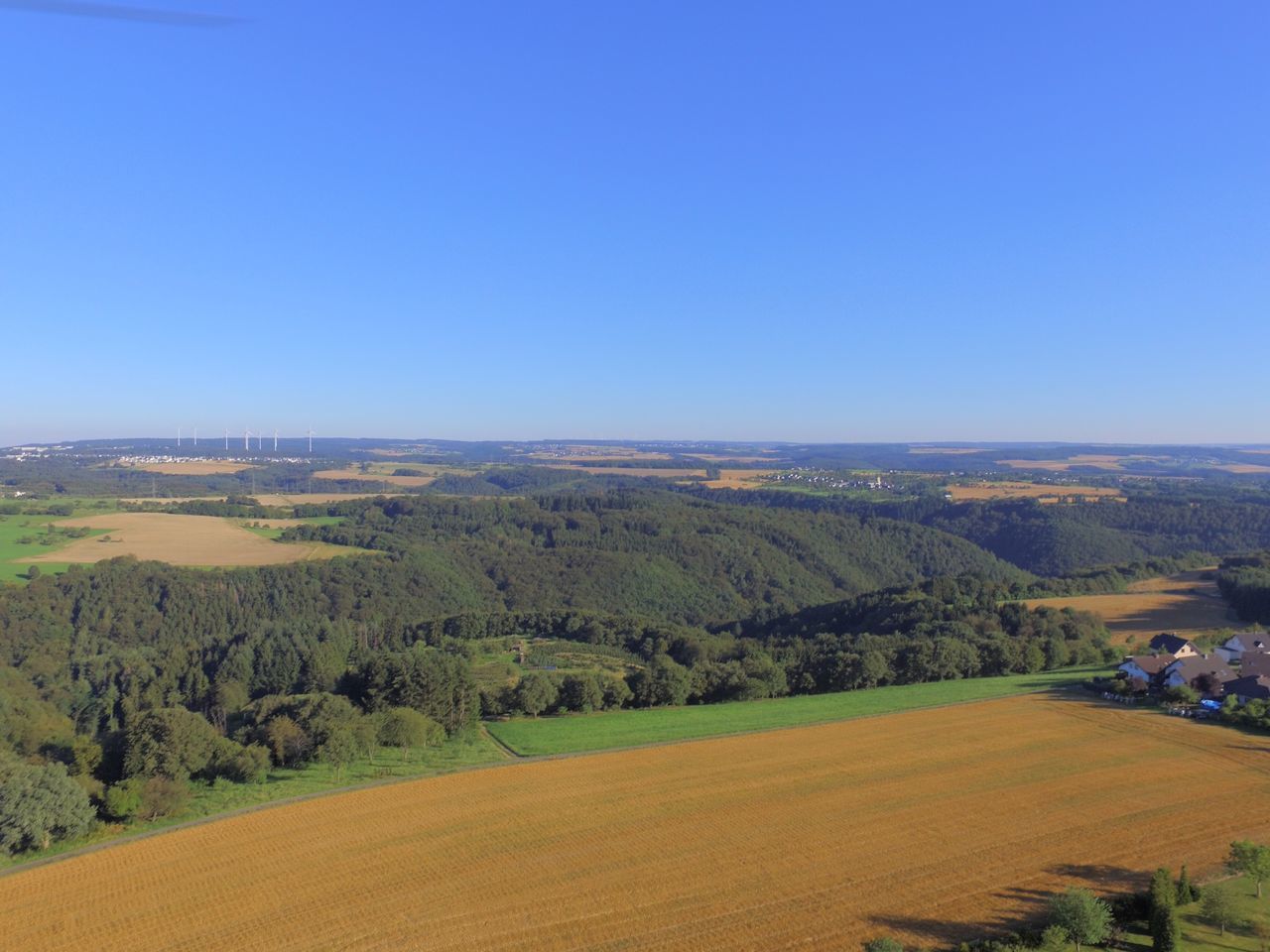 clear sky, tranquil scene, copy space, scenics, landscape, tranquility, blue, beauty in nature, nature, travel destinations, non-urban scene, day, green color, rural scene, growth, tourism, vacations, horizon over land, outdoors, wide shot, mountain, agriculture, horizon, remote