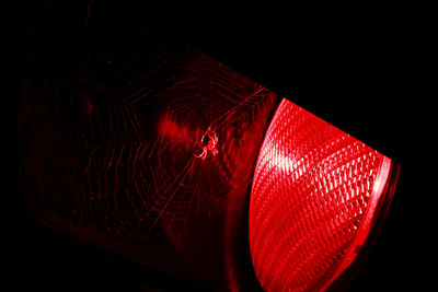 Close-up of illuminated light over black background