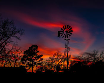 Low angle view of silhouette trees against sky at sunset