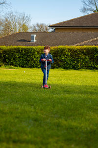 Full length of boy standing on field