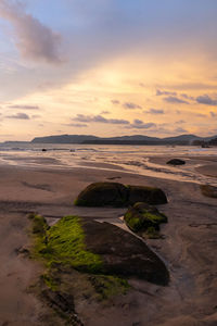 Scenic view of beach against sky during sunset
